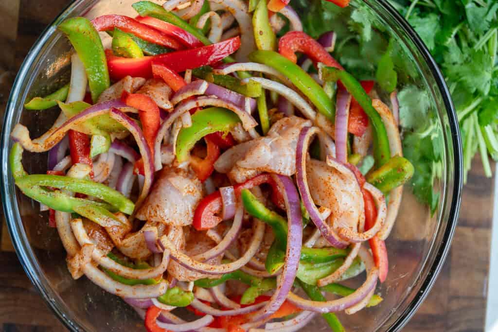 uncooked fajita ingredients in a bowl