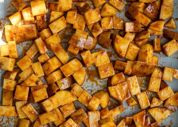 uncooked potatoes on a sheet pan