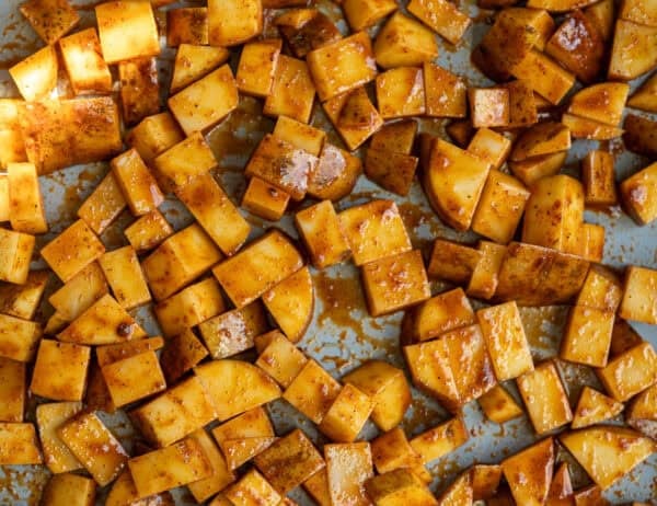 uncooked potatoes on a sheet pan