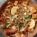 an overhead shot of hot honey halloumi salad in a brown bowl