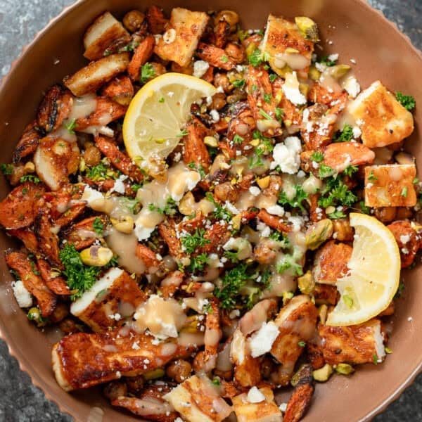 an overhead shot of hot honey halloumi salad in a brown bowl