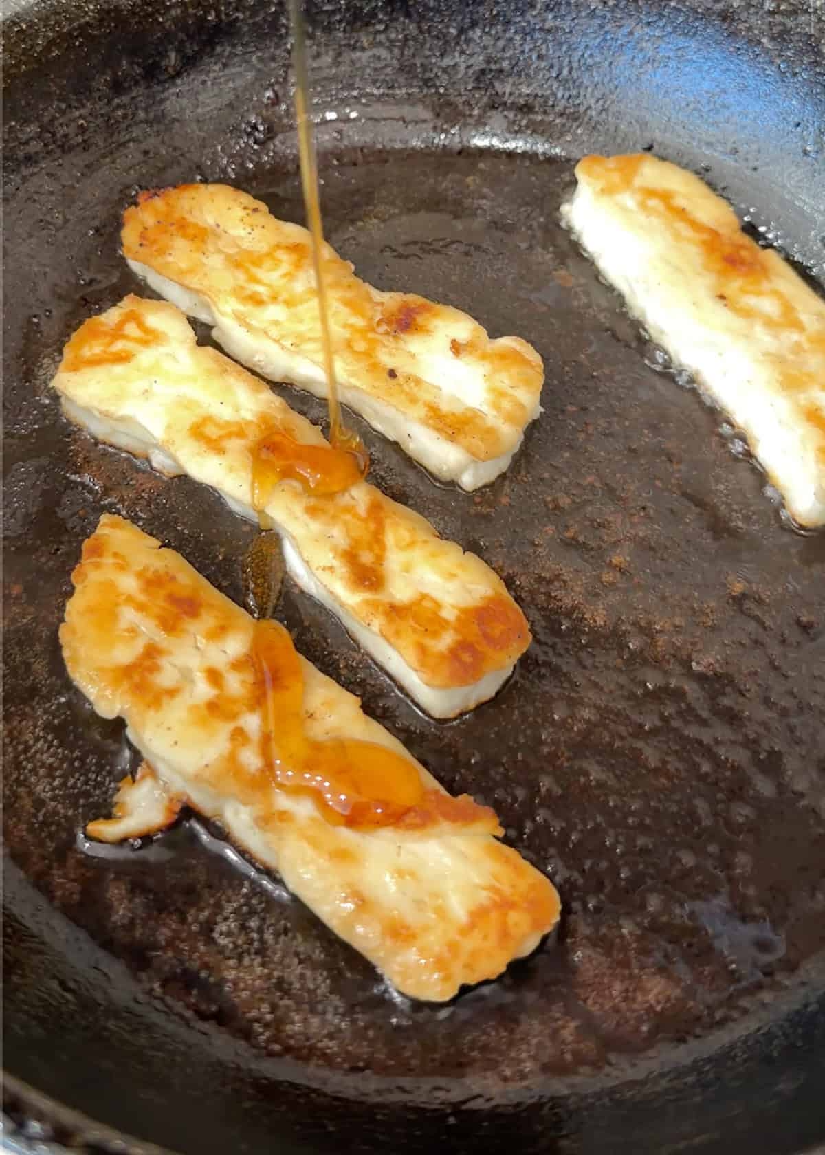 halloumi with honey being drizzled