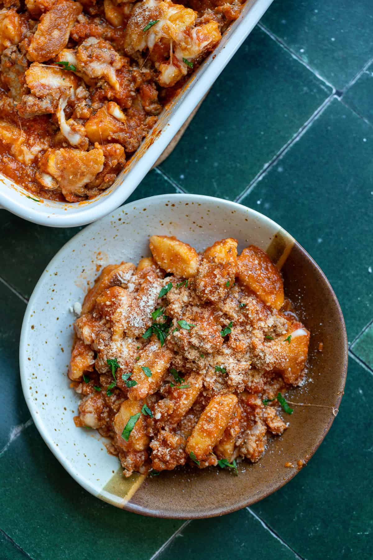 overhead shot of baked gnocchi in bowl and casserole dish