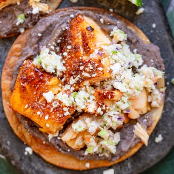 an overhead shot of hot honey salmon on a tostada