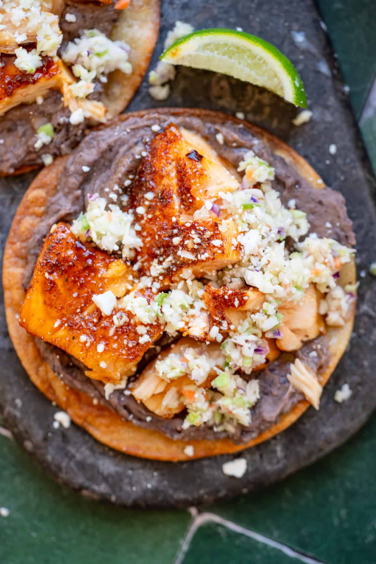 an overhead shot of hot honey salmon on a tostada