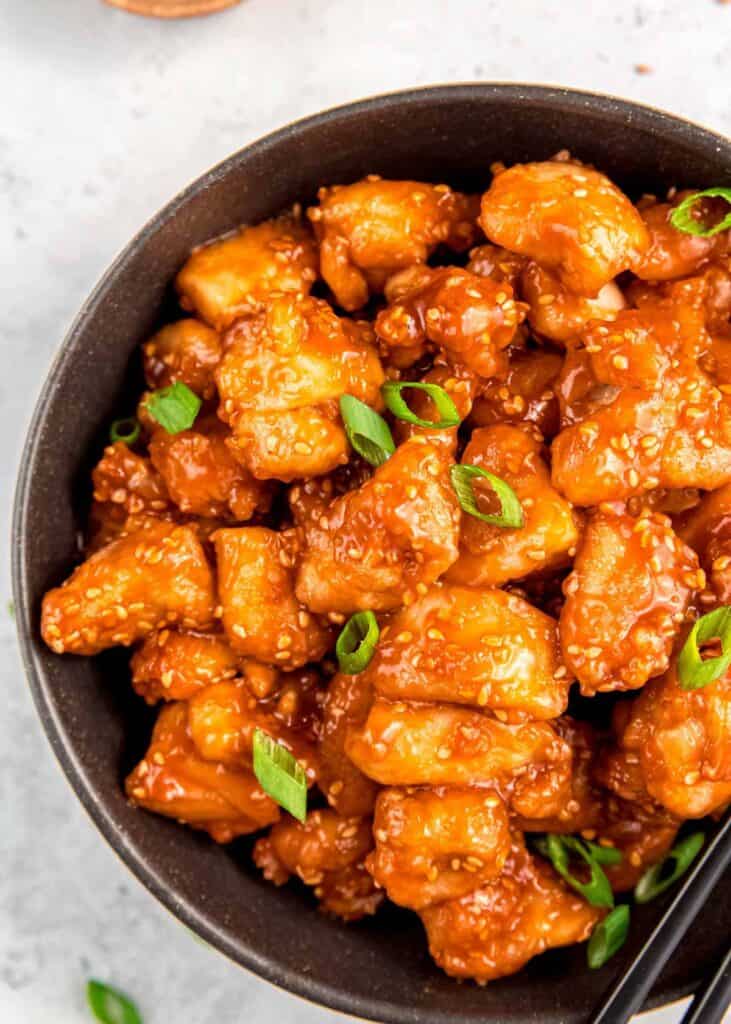 a bowl full of juicy sesame chicken