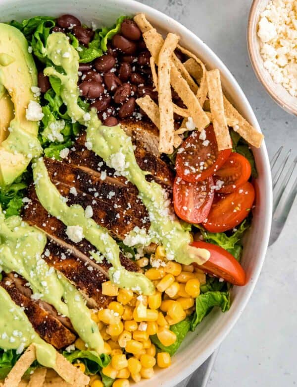 close, overhead image of a southwest chicken salad in a white bowl