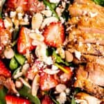 close up image of garnished strawberry spinach salad