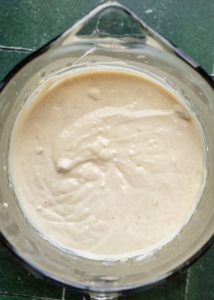 enchilada sauce and cottage cheese mixed in a mixing bowl