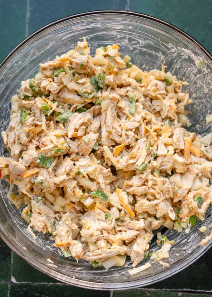 chicken enchilada mixture in a clear mixing bowl