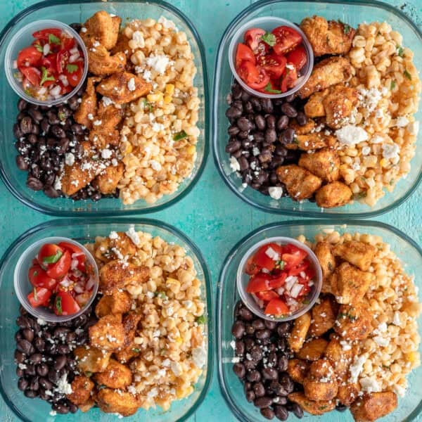 an overhead shot of mexican street corn meal prep bowls