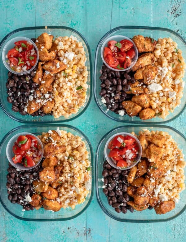 an overhead shot of mexican street corn meal prep bowls