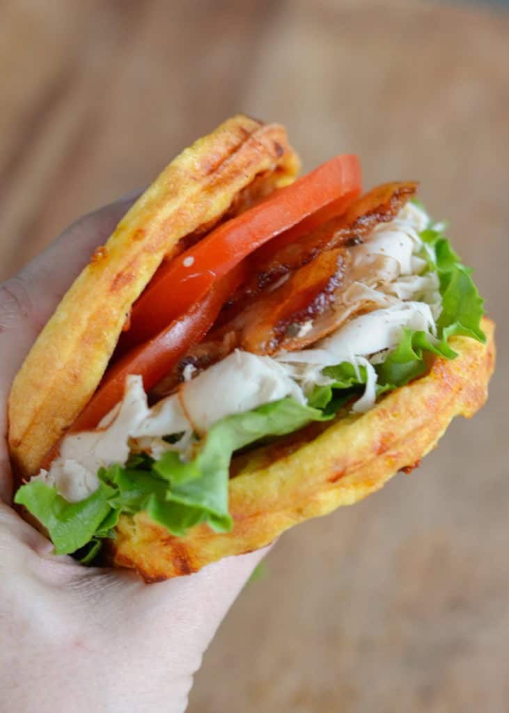 two chaffles filled with deli turkey, crunchy bacon, tomato slices, and fresh lettuce