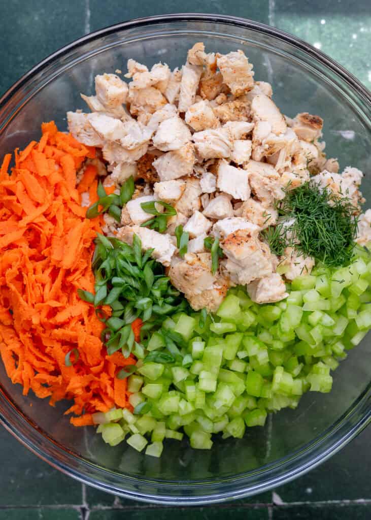 ingredients for chicken salad in a glass bowl