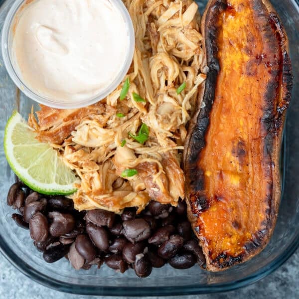 close up image of one honey chipotle chicken bowl in a clear meal prep container