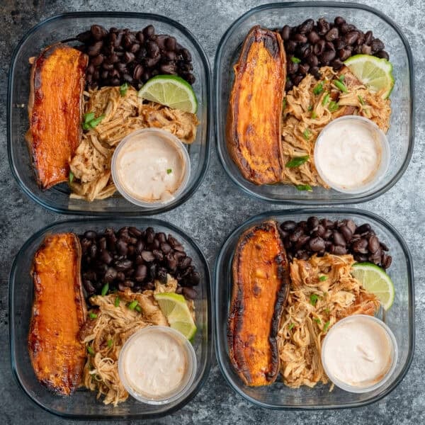 overhead image of 4 honey chipotle chicken bowls in clear meal prep containers