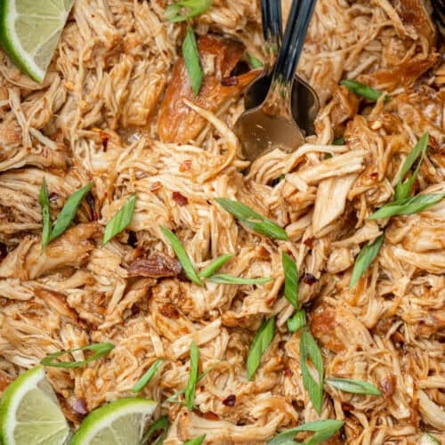 an overhead image of honey chipotle chicken shredded in a slow cooker