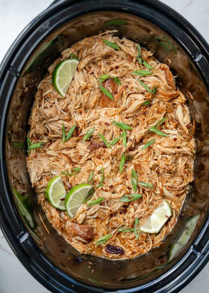 shredded chicken in a slow cooker after being tossed in honey chipotle sauce