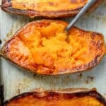overhead image of a roasted sweet potato with a fork inside of it