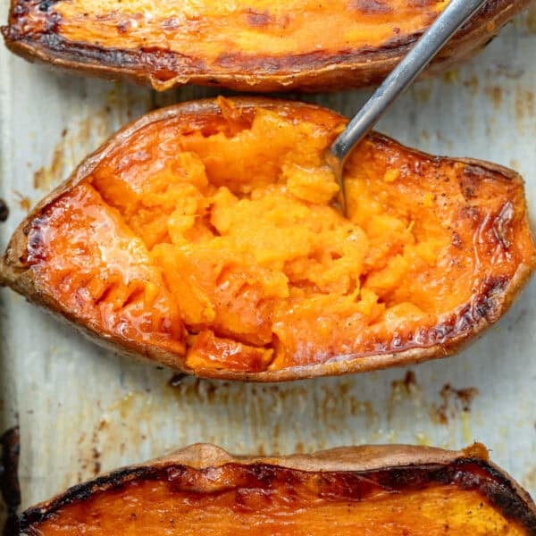 overhead image of a roasted sweet potato with a fork inside of it