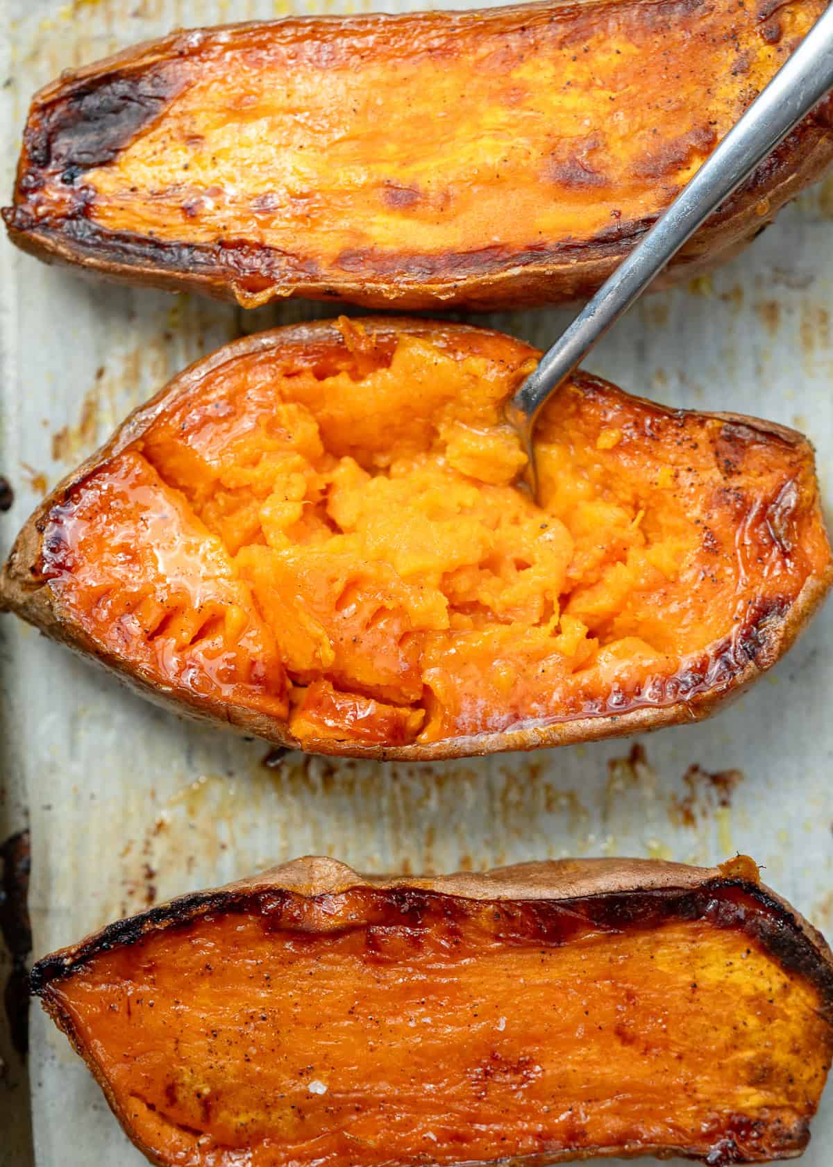 overhead image of a roasted sweet potato with a fork inside of it