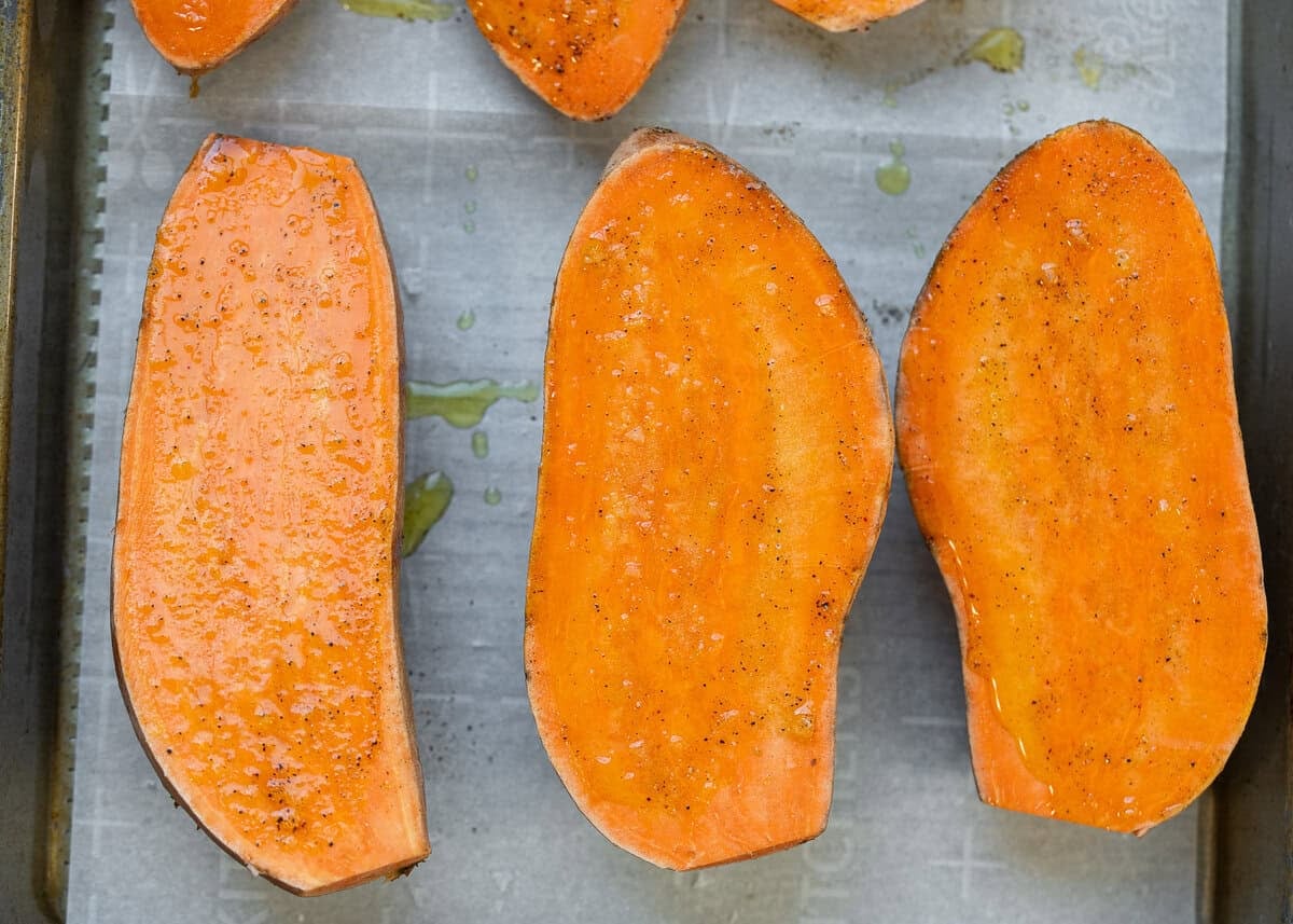 overhead image of sliced sweet potatoes on cooking pan