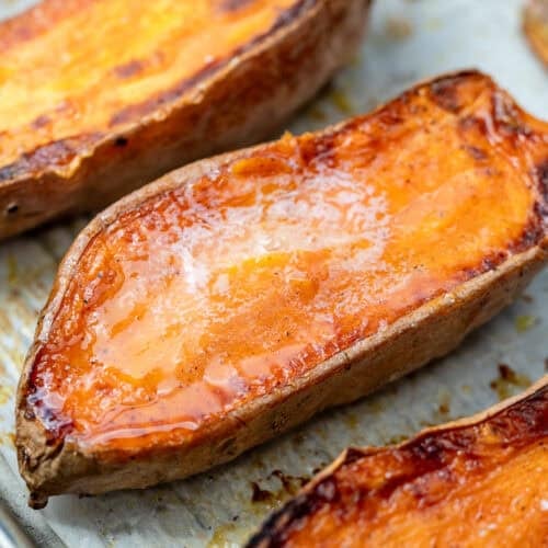overhead image of 3 sliced sweet potatoes on cooking sheet